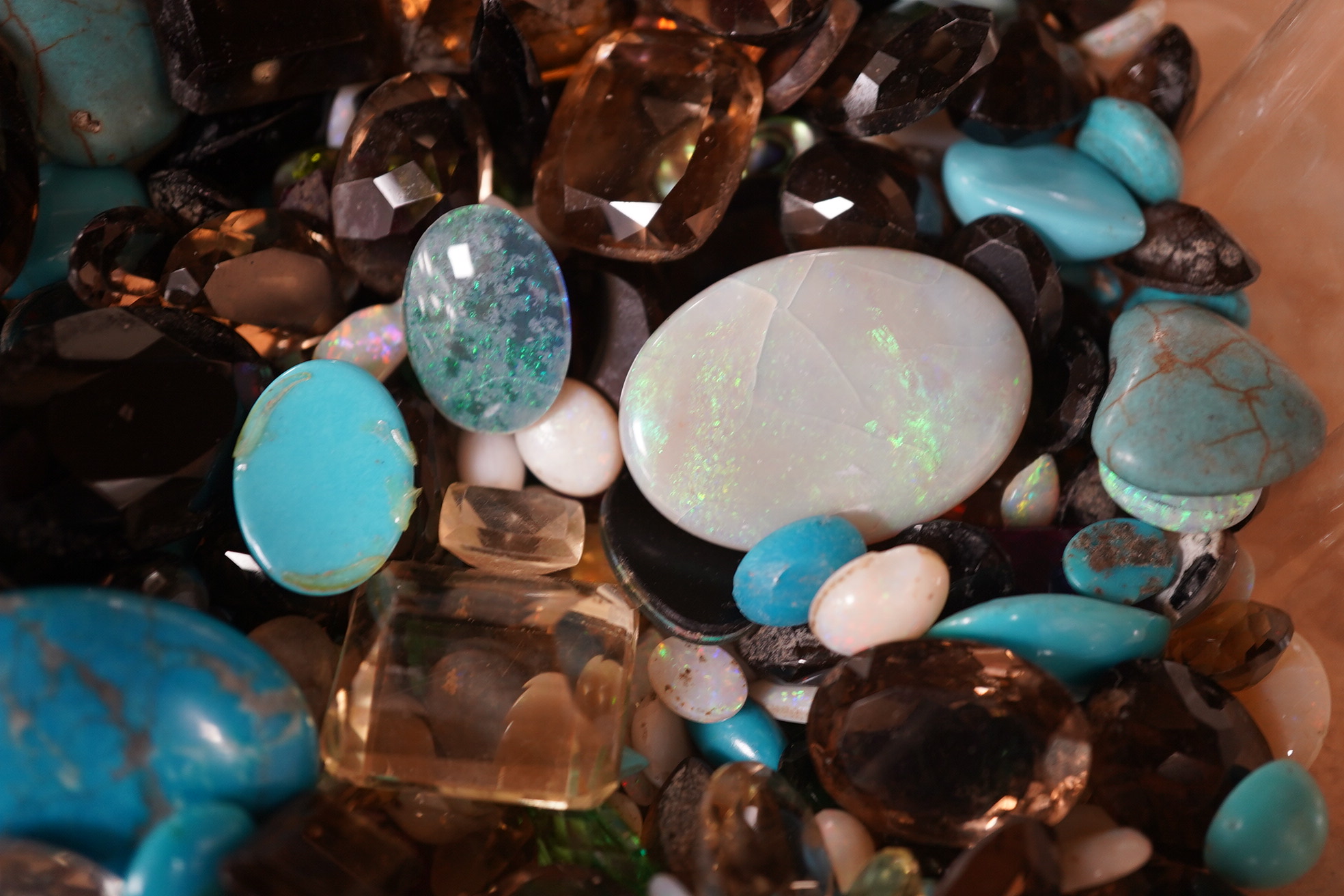 A large quantity of assorted unmounted cut and cabochon gemstones etc, including opal, quartz and turquoise. Condition - poor to fair to good